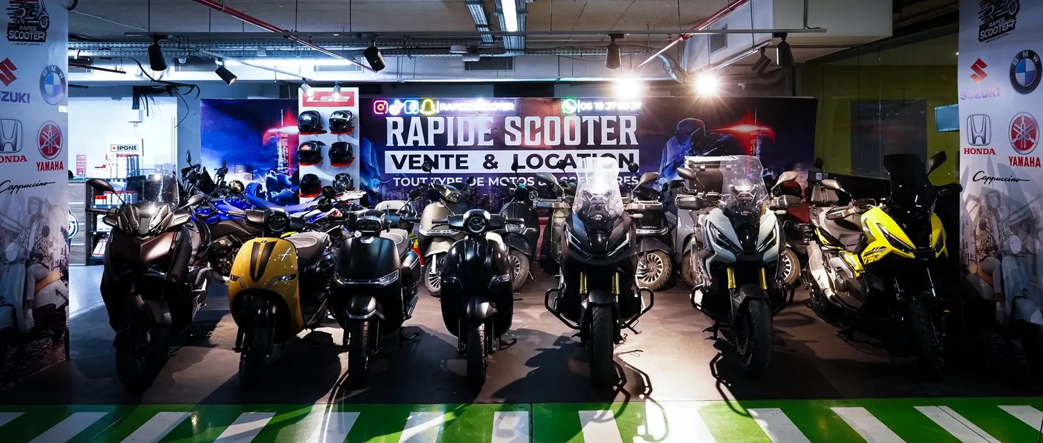 The RapideScooter showroom at Ibn Batouta Mall in Tangier, motorcycles and scooters lined up under the signage, photographed by Mira Visions