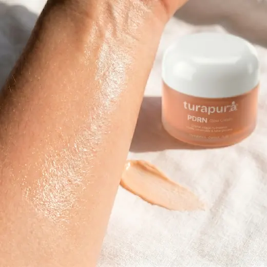 Turapura cream jar beside a treated forearm showing the finish, content by Mira Visions