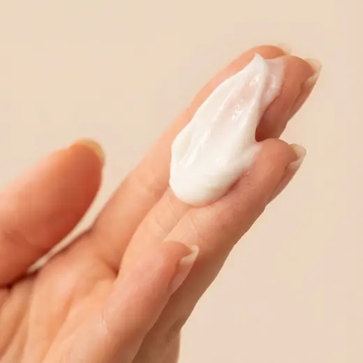 Turapura cream swatch on a fingertip, texture content by Mira Visions