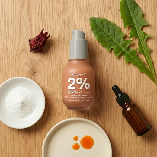 Turapura serum with dandelion, hibiscus and dropper ingredients laid out on wood, content by Mira Visions