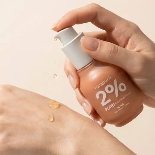 Turapura serum dispensed onto the back of a hand, texture content by Mira Visions